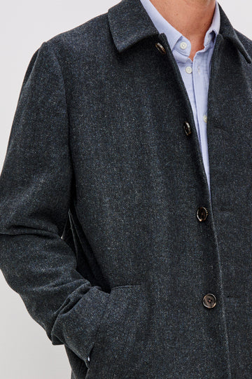 Hockney is a traditional top coat, wool-blended and lined with welt pockets, interior pockets on both sides (invisible zipper and welt), and a back vent, in Celestial Tweed Color. Front detailed view featured on model.