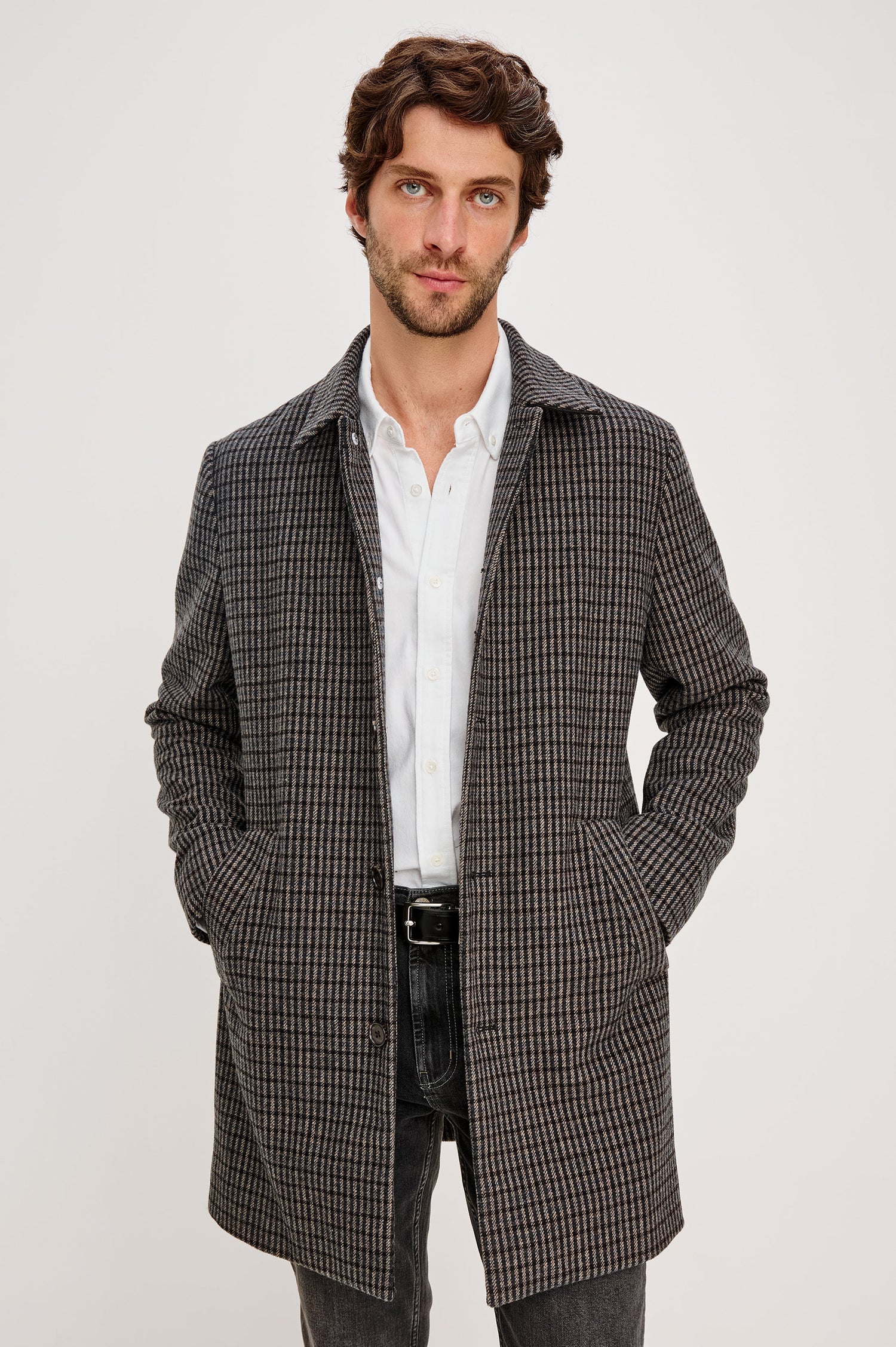 Hockney Mid-Thigh Length Overcoat with Button Closure, Two Front Pockets, and a Back Vent in Grey Check Plaid Colorway, a plaid in Grey, Black and Blue - Front View Featured on Model
