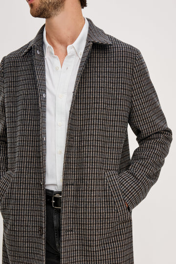Hockney Mid-Thigh Length Overcoat with Button Closure, Two Front Pockets, and a Back Vent in Grey Check Plaid Colorway, a plaid in Grey, Black and Blue - Front detail View Featured on Model