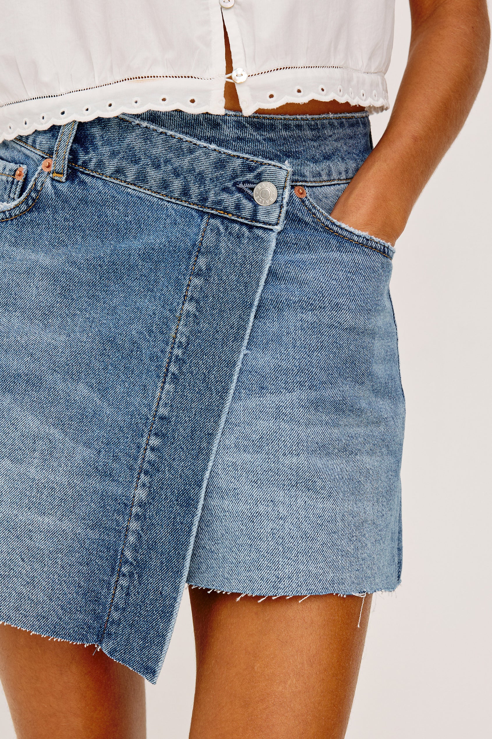 Huntington Mini Skirt in Rigid Denim With High-Rise, and Wrap-Style Front with a Button Closure in Windsurf Colorway - Lower Body Front View Featured on Model