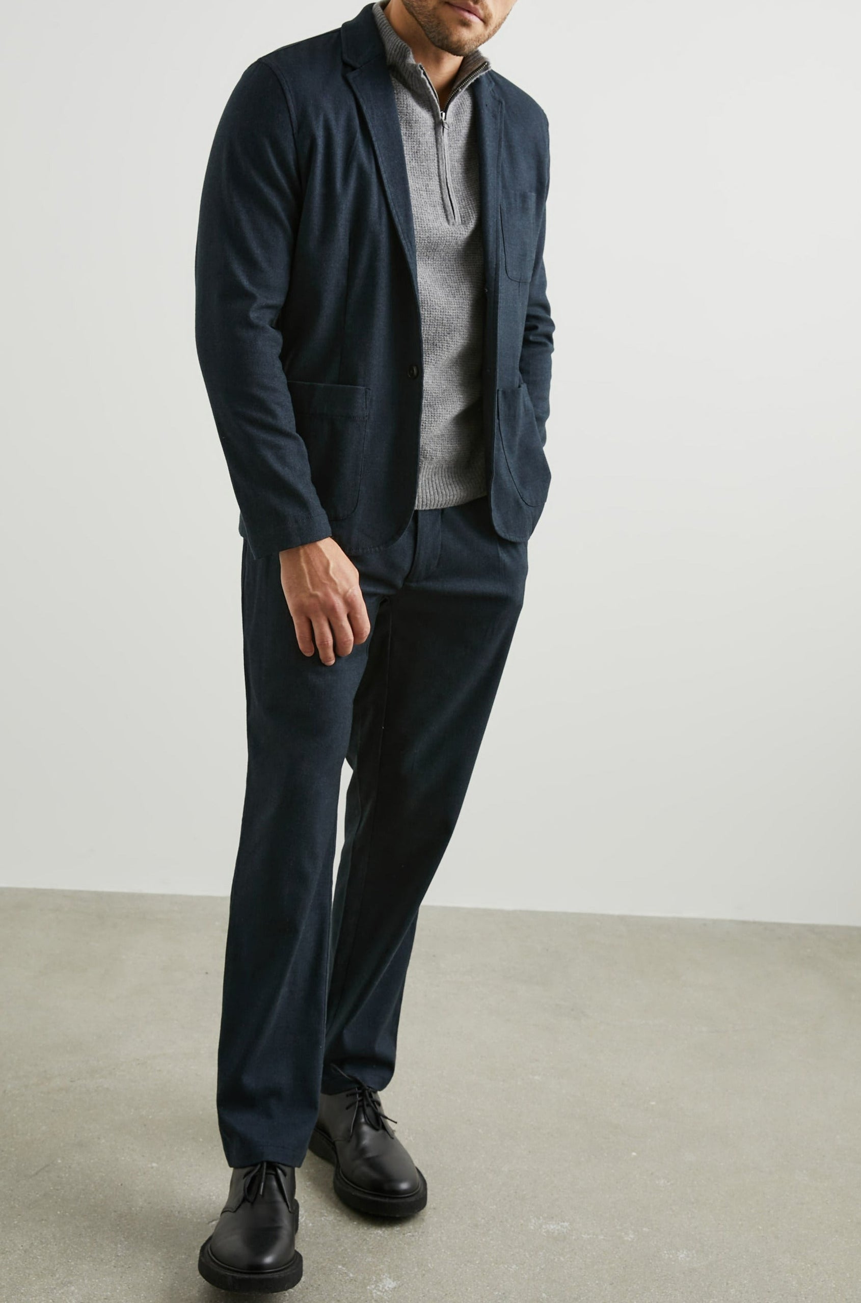 Idris Blazer with Two Button Closure, Two Front Patch Pockets, a Chest Patch Pocket and Three-Button Cuffs in Dark Navy Colorway - Front Full Body View Featured on Model