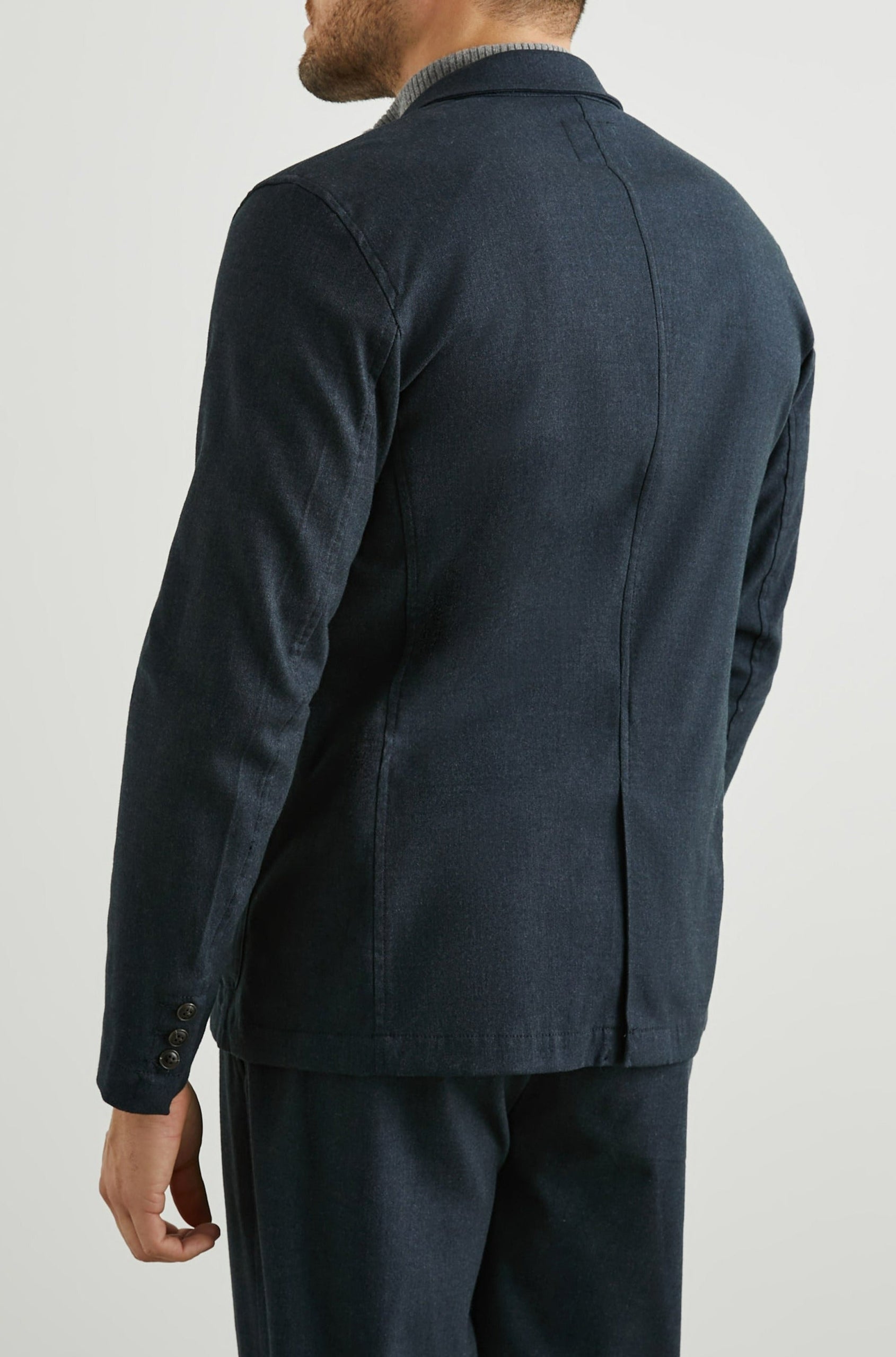 Idris Blazer with Two Button Closure, Two Front Patch Pockets, a Chest Patch Pocket and Three-Button Cuffs in Dark Navy Colorway - Back View Featured on Model