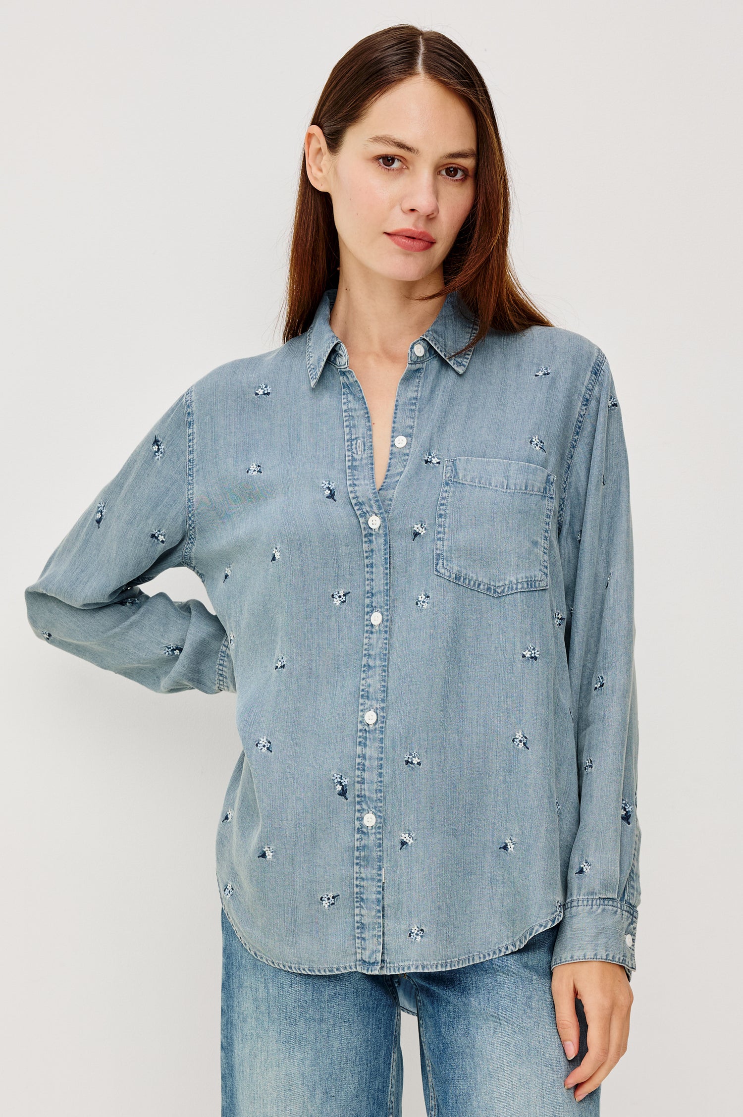 Ingrid Button-Up Collared Shirt in TENCEL™Denim With Vintage-Inspired Wash, Floral Embroidery, a Chest Patch Pocket, and Long Sleeves in Blossoms Colorway - Upper Body Front View Featured on Model
