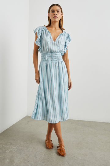 Iona Short Sleeve Midi Dress with Flutter Sleeves, a Deep V Neck with Ties, and a Shirred Waist in Cambria Stripe Colorway, Vertical Stripes in White, Blue and Light Blue - Front Full Body View Featured on Model 