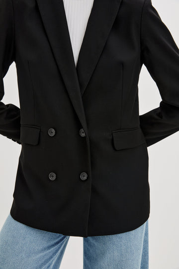 Jac Double-Breasted Blazer with Two Front Flap Pockets and a Notched Label in Black Twill Colorway - Front View Featured on Model