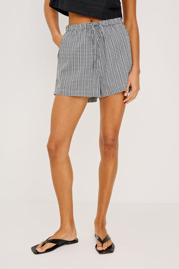 Jenner High-Waisted Short in Unlined Linen With Adjsutable Drawstring Waist TIes Side Pockets and Relaxed Fit in Black Gingham Colorway - Lower Body Front View Featured on Model
