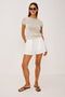 Jenner Short in Linen With High-Rise, Adjustable Drawstring Ties, Relaxed Fit, and Side Pockets in White Colorway - Full Body Front View Featured on Model