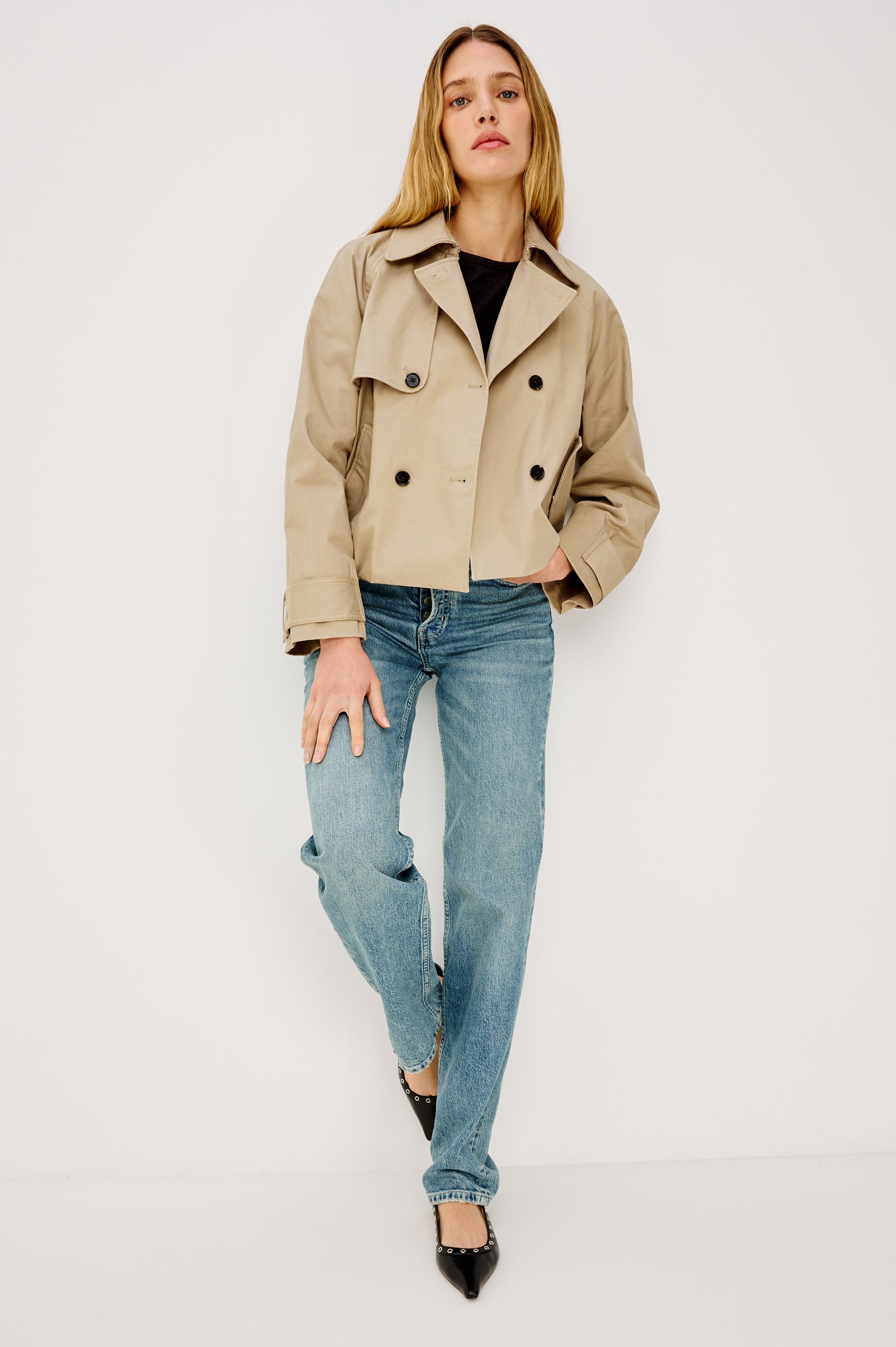 Jett Double Breasted, Cropped Trench Jacket, Lapel, Adjustable Cuff Belt, Side Pockets and Elasticated Hem in Taupe Colorway. Front View Featured on Model.