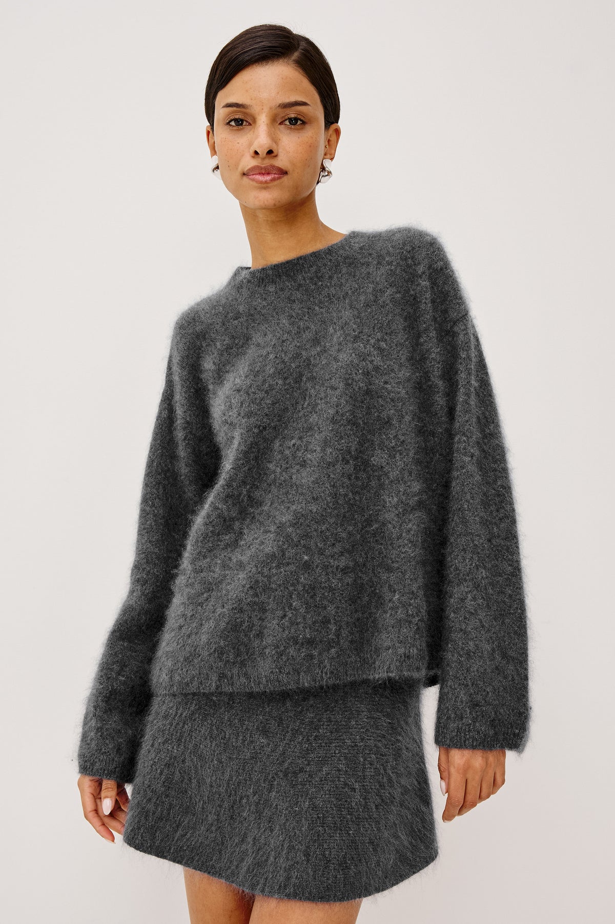 Joel Sweater in Brushed Wool With Oversized Boxy Relaxed Fit, Drop Shoulders, and Mock Neckline in Charcoal Colorway - Upper Body Front View Featured on Model