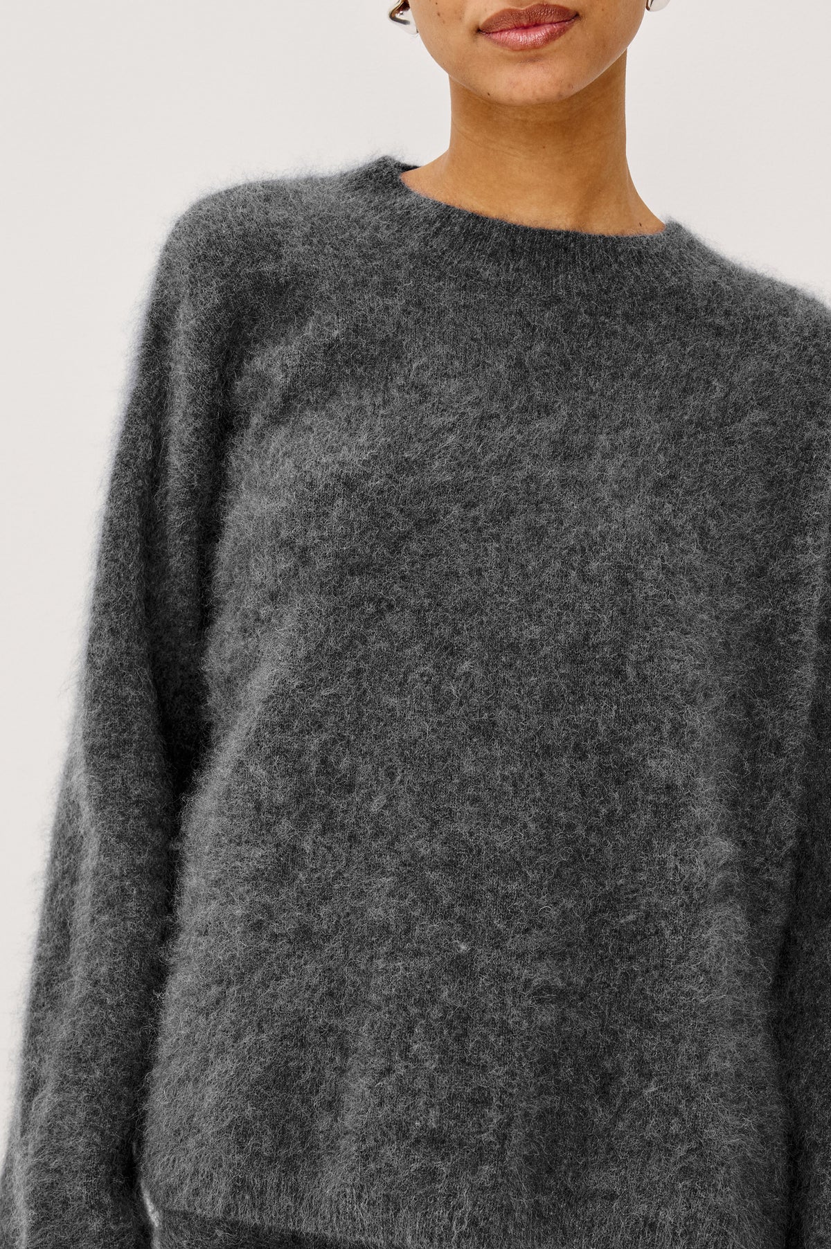 Joel Sweater in Brushed Wool With Oversized Boxy Relaxed Fit, Drop Shoulders, and Mock Neckline in Charcoal Colorway - Upper Body Front View Featured on Model