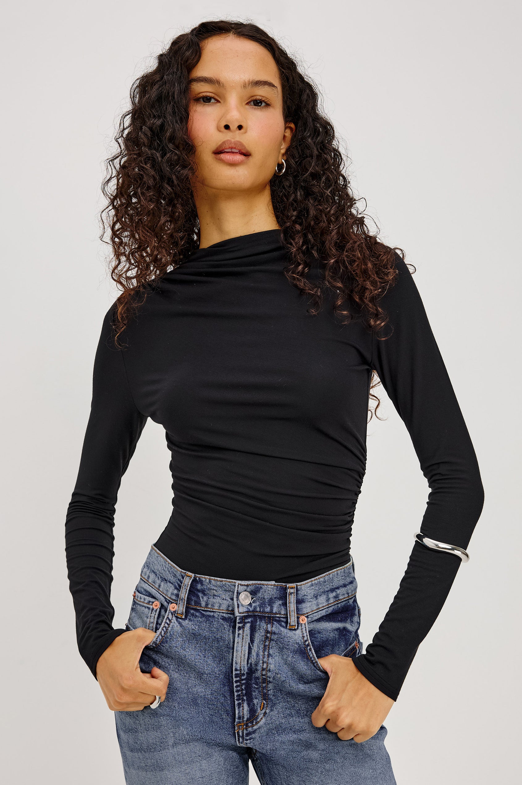 Joelle Top in Soft Jersey With High Funnel Neckline, Long Sleeves, Self-Lined Body, and Asymmetric Ruching at Shoulder and Waist in Black Colorway - Upper Body Front View Featured on Model