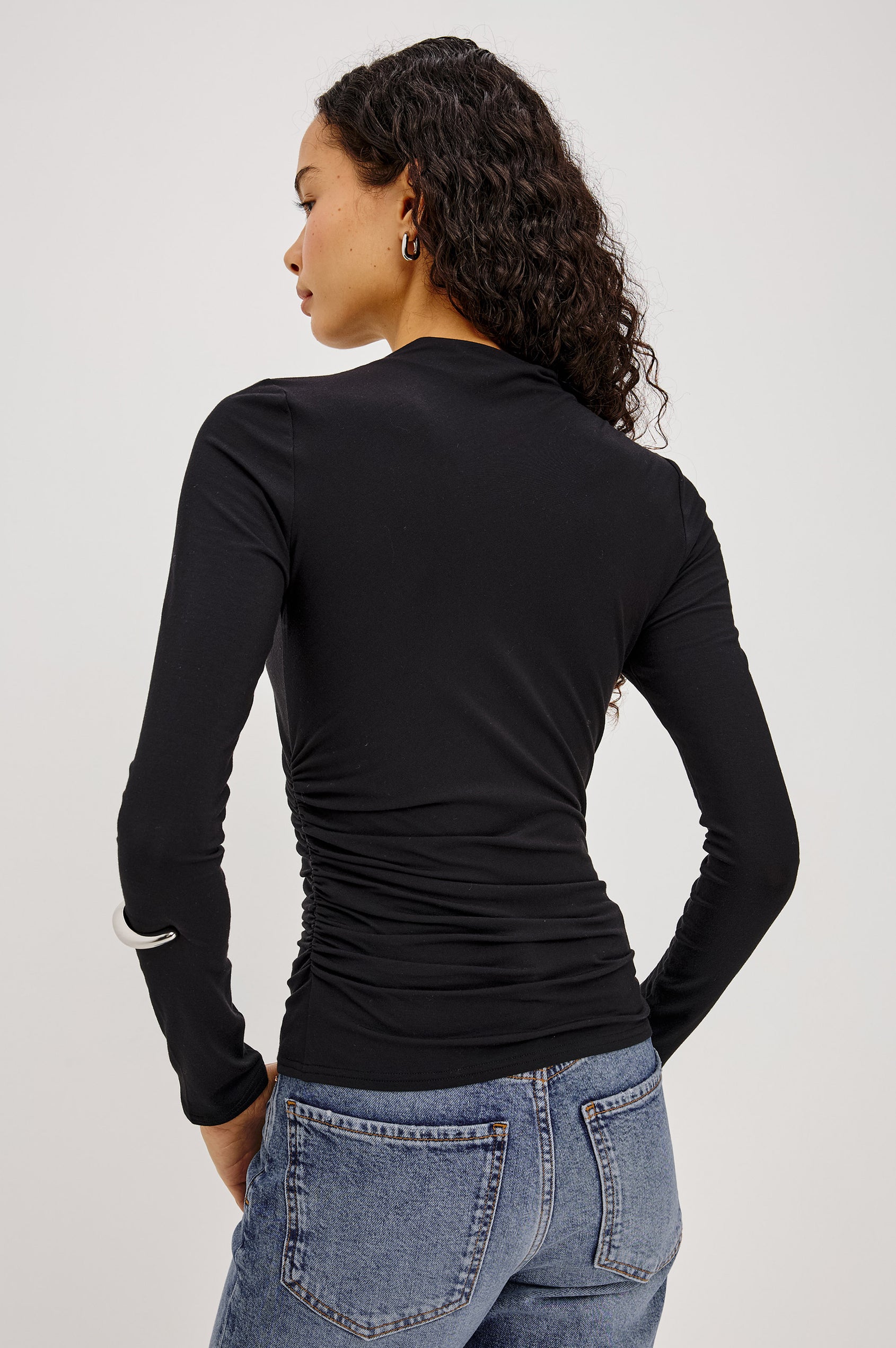 Joelle Top in Soft Jersey With High Funnel Neckline, Long Sleeves, Self-Lined Body, and Asymmetric Ruching at Shoulder and Waist in Black Colorway - Upper Body Back View Featured on Model