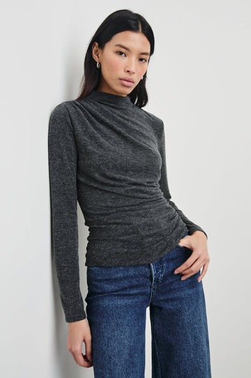 Joelle Long Sleeve Top with An Asymmetrical Mock Neck and Shirring on the Right Shoulder in Charcoal Colorway - Front View Featured on Model
