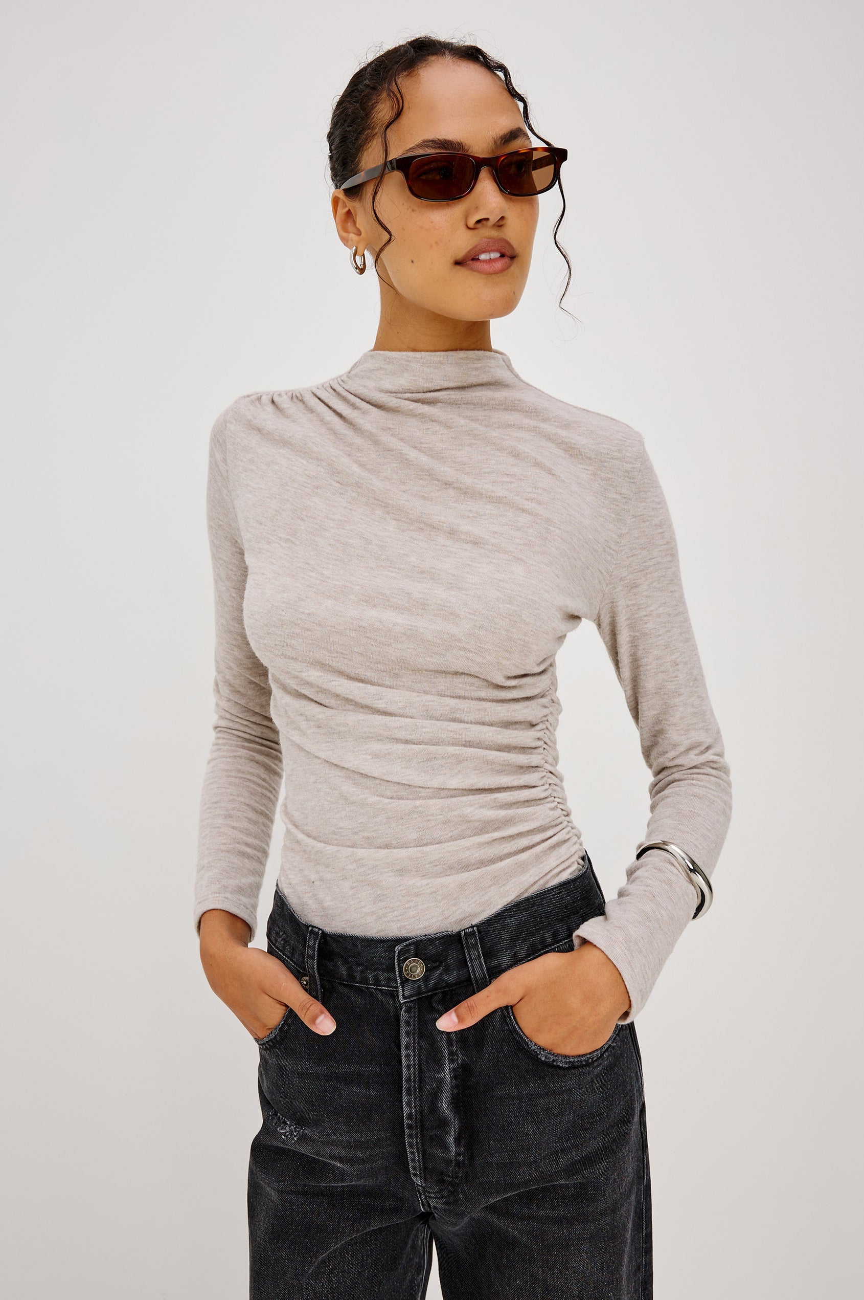 Joelle Top Fitted in Jersey With High Funnel Neckl, Long Sleeves, and Asymmetric Shoulder Shirring in Heather Oatmeal Colorway - Upper Body Front View Featured on Model