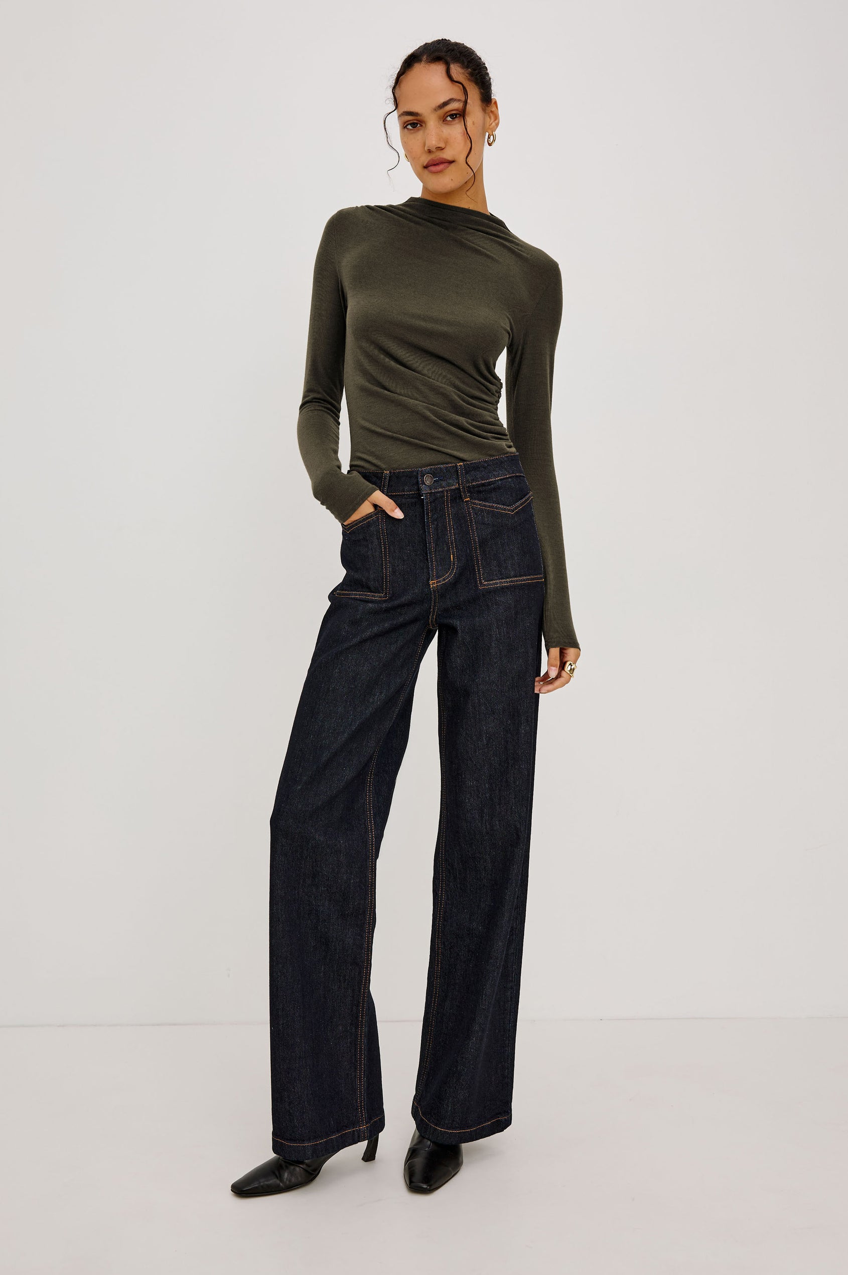 Joelle Top Fitted in Jersey With High Funnel Neckl, Long Sleeves, and Asymmetric Shoulder Shirring in Heather Olive Colorway - Full Body Front View Featured on Model