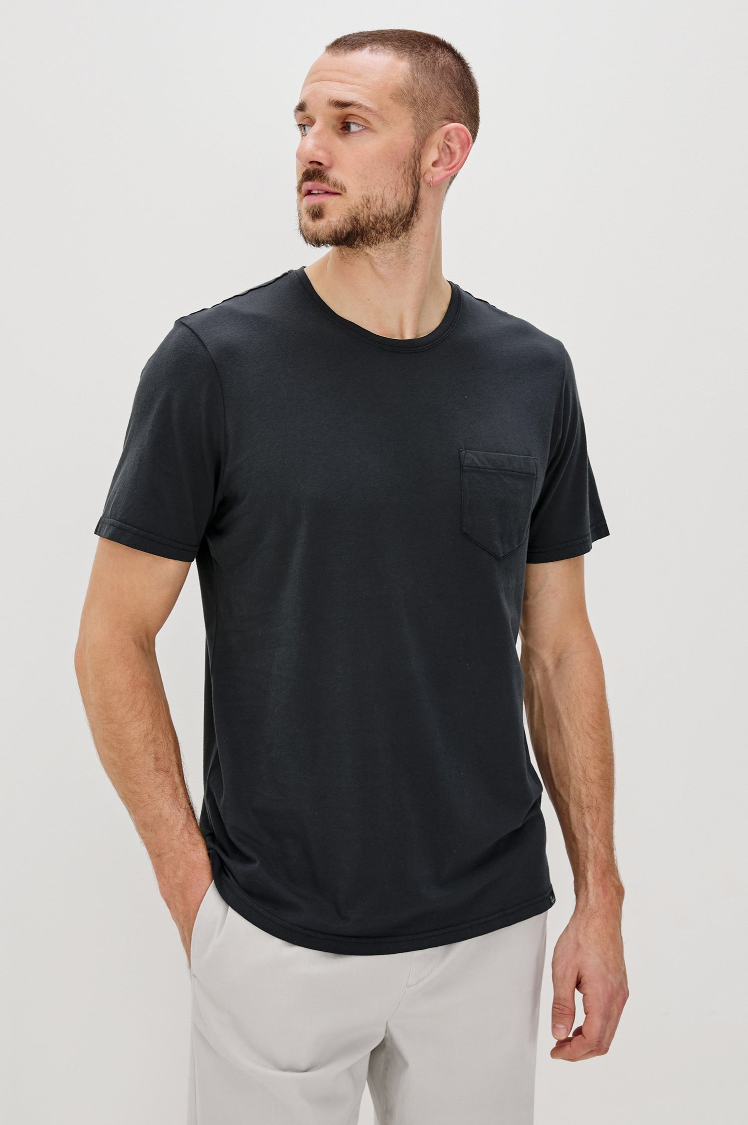 Johnny Short Sleeve T-Shirt with a Crew Neck, Chest Patch Pocket and Small Slits at the Side Hems in Carbon Colorway - Front View Featured on Model