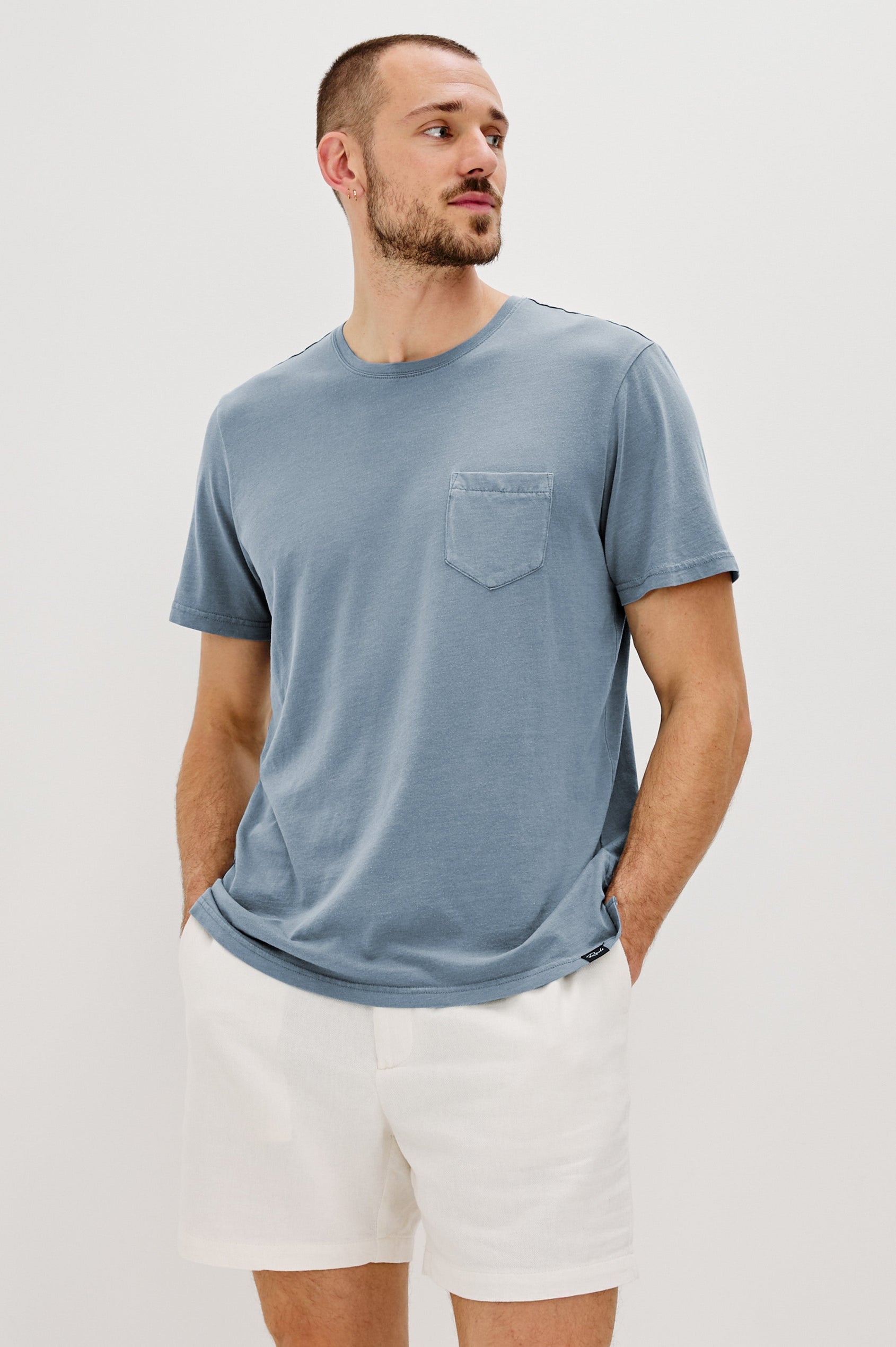 Johnny Short Sleeve T-Shirt with a Crew Neck, Chest Patch Pocket and Small Slits at the Side Hems in Steel Colorway - Front View Featured on Model