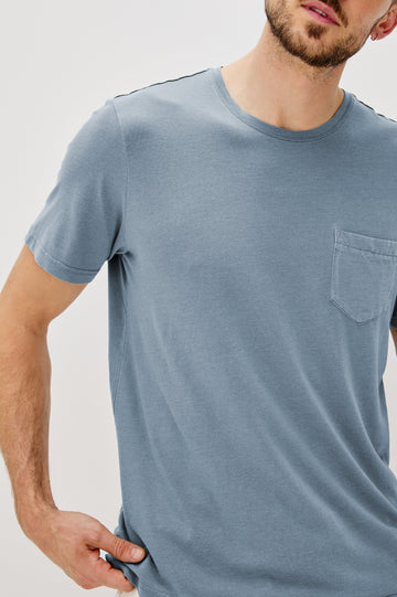 Johnny Short Sleeve T-Shirt with a Crew Neck, Chest Patch Pocket and Small Slits at the Side Hems in Steel Colorway - Front Detail View Featured on Model