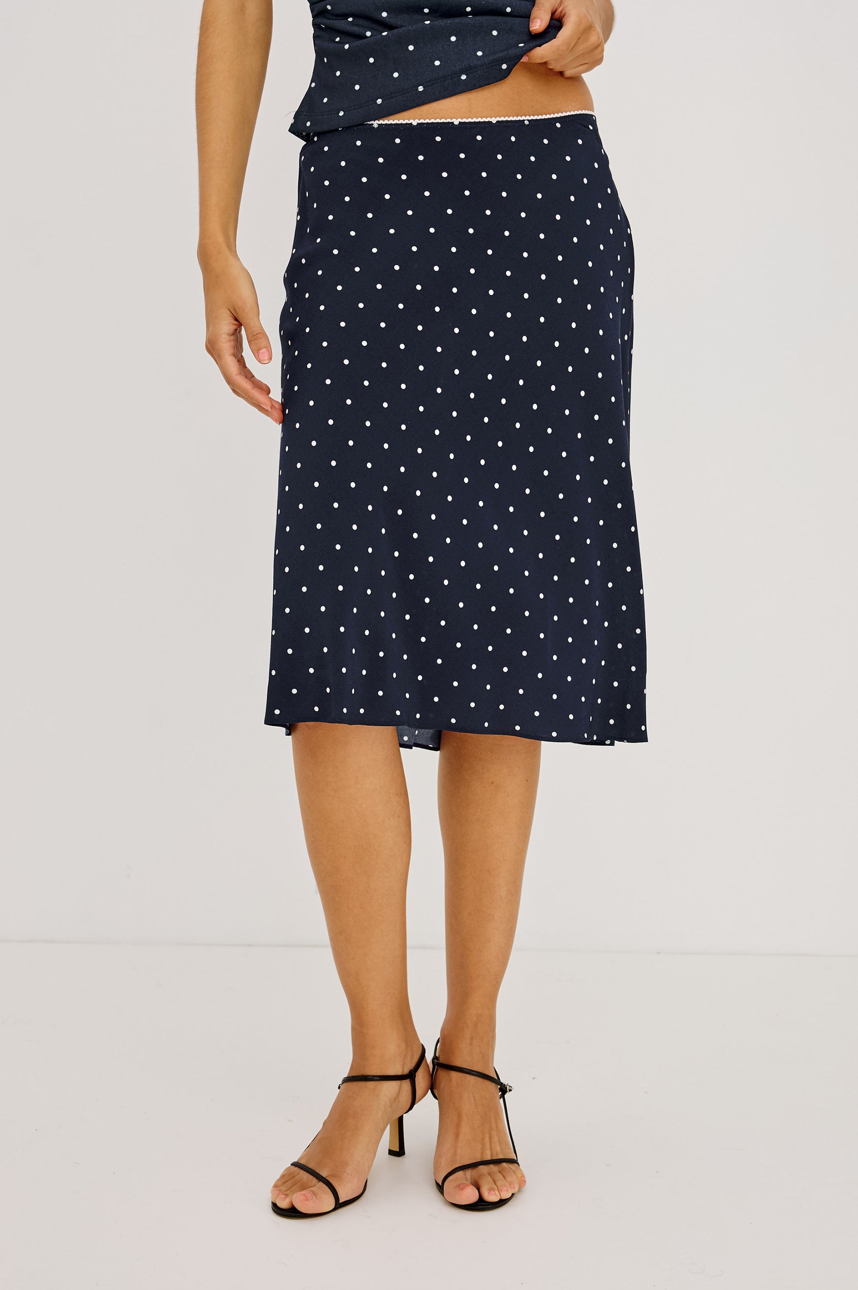 Jolene Midi Skirt in Rayon Crepe With Scalloped Elastic Waistband in Navy Polka Dots Colorway - Lower Body Front View Featured on Model
