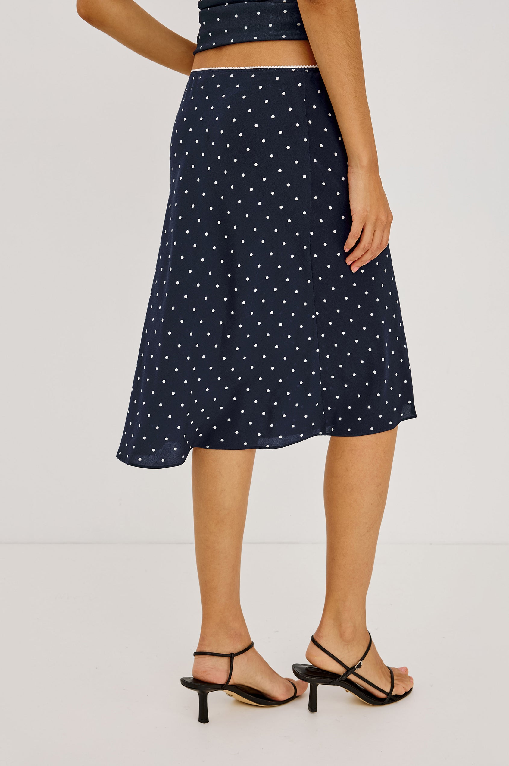 Jolene Midi Skirt in Rayon Crepe With Scalloped Elastic Waistband in Navy Polka Dots Colorway - Lower Body Front View Featured on Model