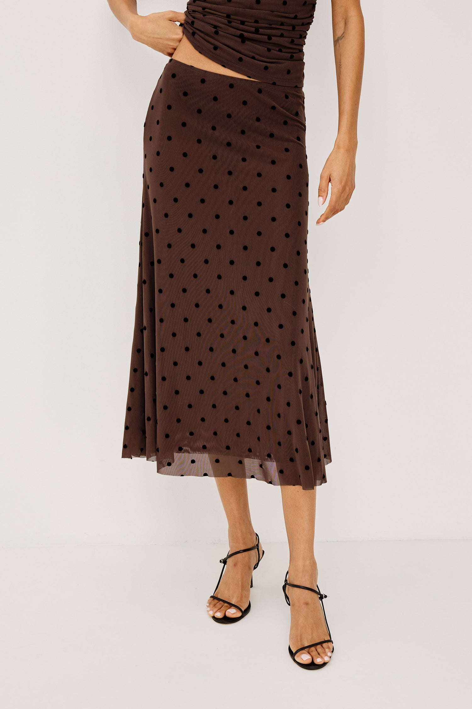 Jordan Midi Skirt in Stretch Mesh With Velvet Flocked Details, A-Line Fit, Full Lining, and Elastic Waistband in Chocolate Polka Dot Colorway - Full Body Front View Featured on Model