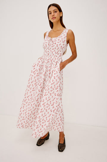 Jordie Maxi Dress in Cotton Voile With A-Line Silhouette, Rounded Square Neckline, Ruffle Trim, Center-Front Bust Cutrout With Self-Ties, Smocked Waist, Side Pockets, and Fully Lined Skirt in Rouge Romantic Colorway - Full Body Front View Featured on Model
