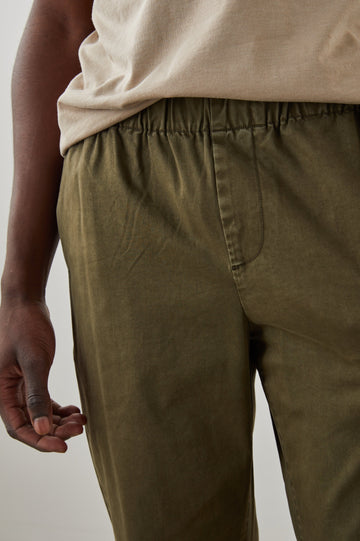  Julian Pants with an Elastic Waist, Two Front Pockets and Two Back Welt Pockets in Moss Colorway - Front View Featured on Model 