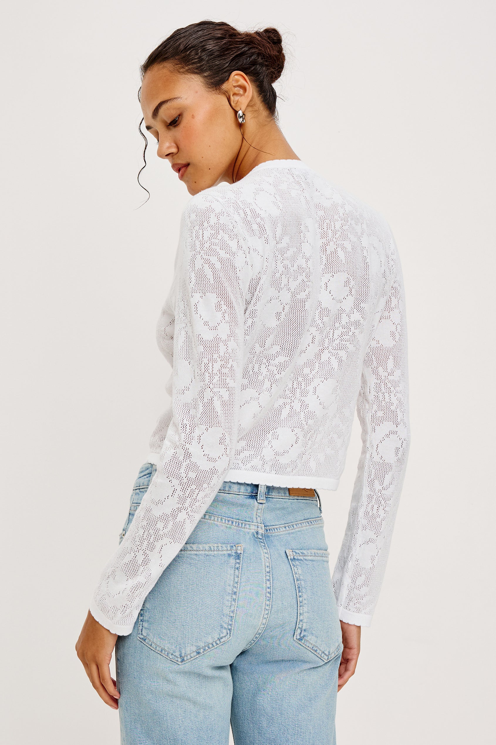 July Cardigan in Semi-Sheer Cotton With Floral Crochet Detailing Scalloped Trim Boxy Cropped Silhouettes and Long Sleeves in White Colorway - Upper Body Back View Featured on Model