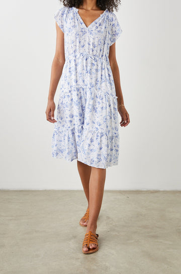 Juni Short Sleeve Midi Dress with a V Neck, Light Ruching along the Neckline, a Drawstring Waist, and a Tiered Skirt in Blue Blossoms Colorway, on White - Front Full Body View Featured on Model