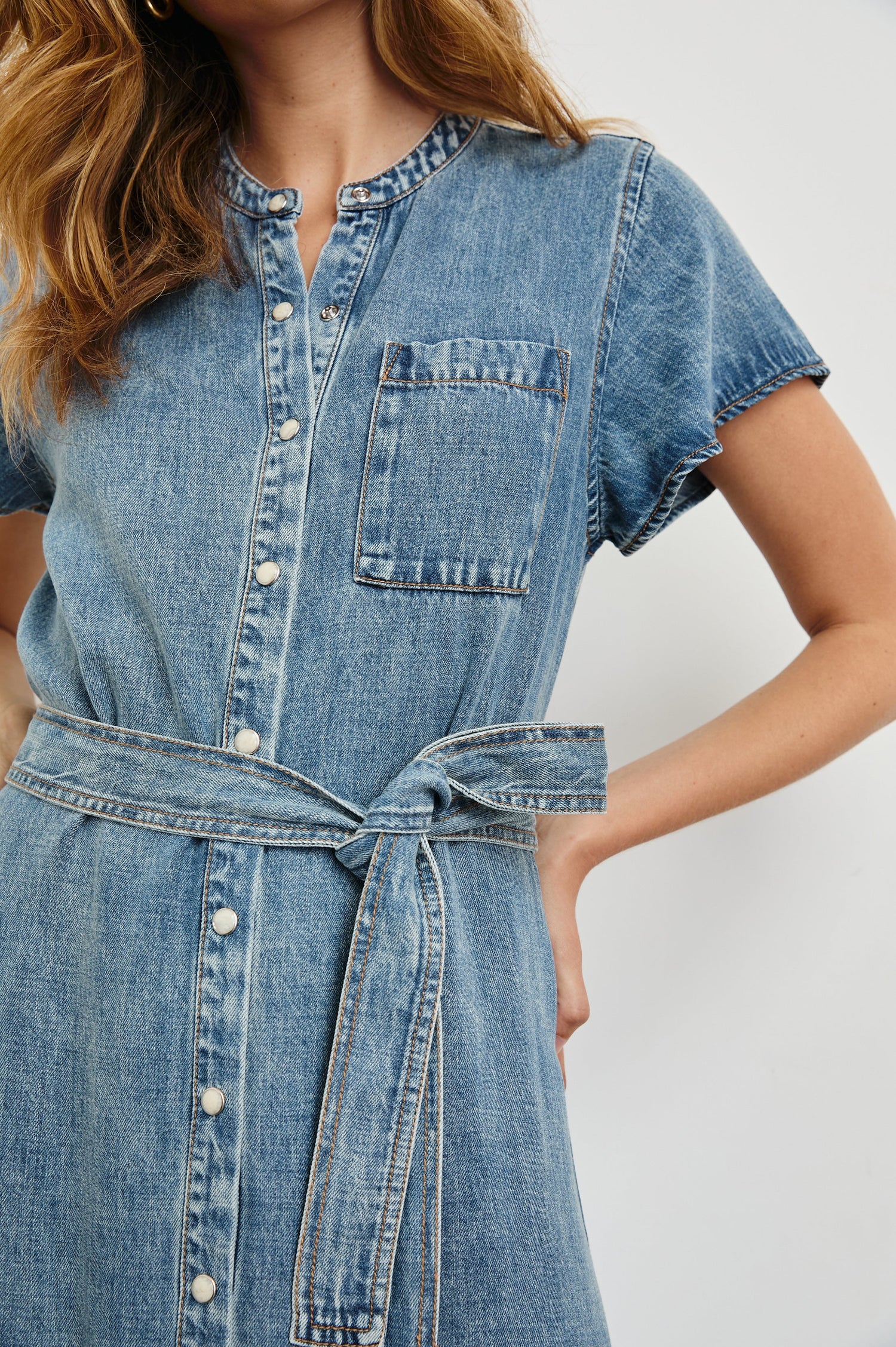 Kahlo Short-Sleeve Midi Dress with Snaps Down the Front, a Waist Tie, a Chest Patch Pocket and a Pleated Hem in Mid Blue Colorway - Front View Featured on Model
