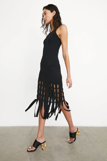 Kaia Sleeveless Midi Dress with a V Neck and Vertical Dashed Cutouts From the Thigh Downward, ending in Panels in Black Colorway - Side Full Body View Featured on Model
