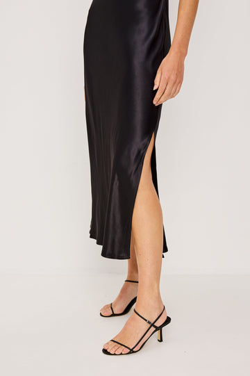Kailani Sleeveless Midi Dress with Shoulder Straps, a Scoop Neck and Side Slit to the Knee in Black Satin Crepe Colorway - Close up of slit Featured on Model