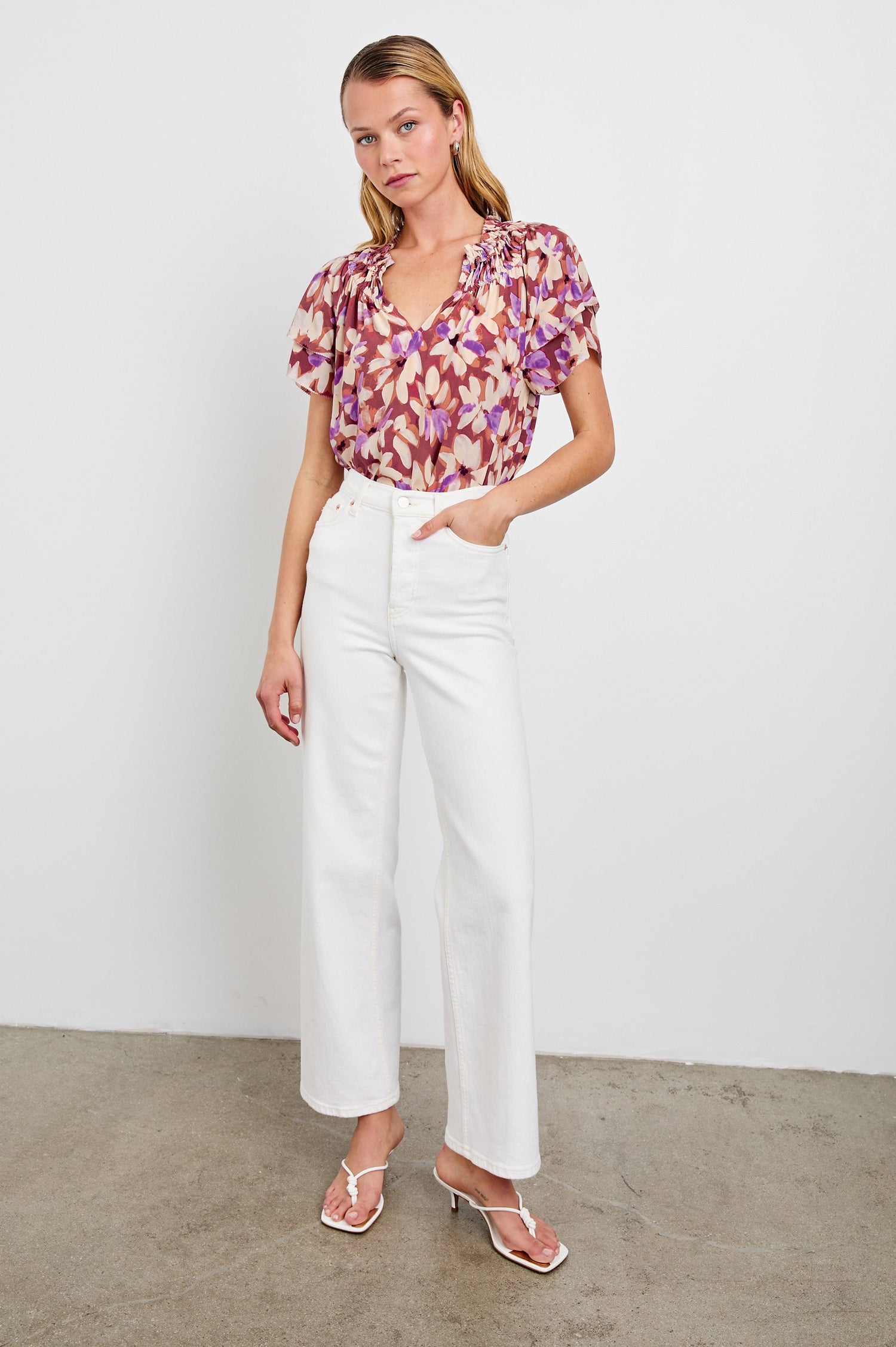 Kamila loose fit short sleeve shirt with a v neckline, ruffled collar, and flutter sleeves in Amaranth Colorway - full body front view on model