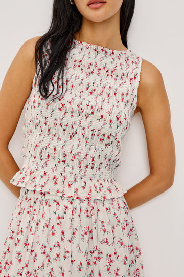 Kane Sleeveless Fitted Top in Cotton With Diamond Smocking All Over High Boat Neckline and Flared Ruffle Hem in Rouge Romantic Colorway - Upper Body Close Up Front View Featured on Model