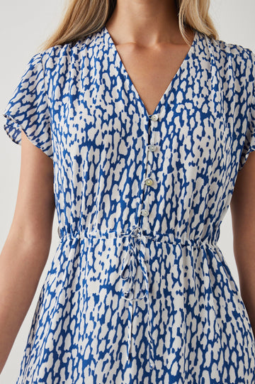 Kiki Short Sleeve Midi Dress with a V Neck, Buttons Down the Front Bodice, a Drawstring Waist and Ruffles at the Hem in Cobalt Static Leopard Colorway, a Blue and White Print - Front View Featured on Model 
