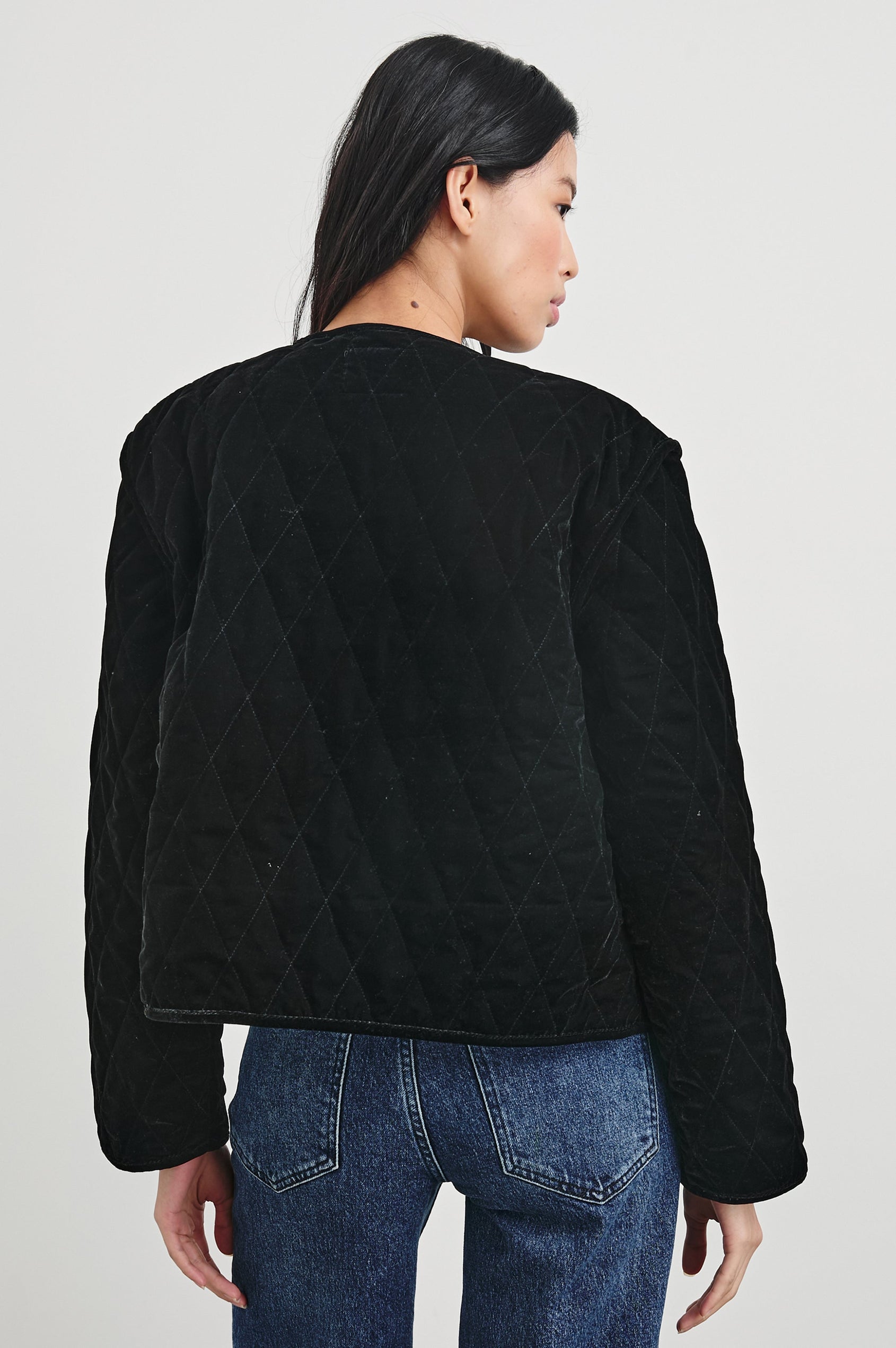 Kiko Jacket with Button Closure, a V Neck, Two Front Patch Pockets and a Quilted Appearance in Black Velvet Colorway - Back View Featured on Model