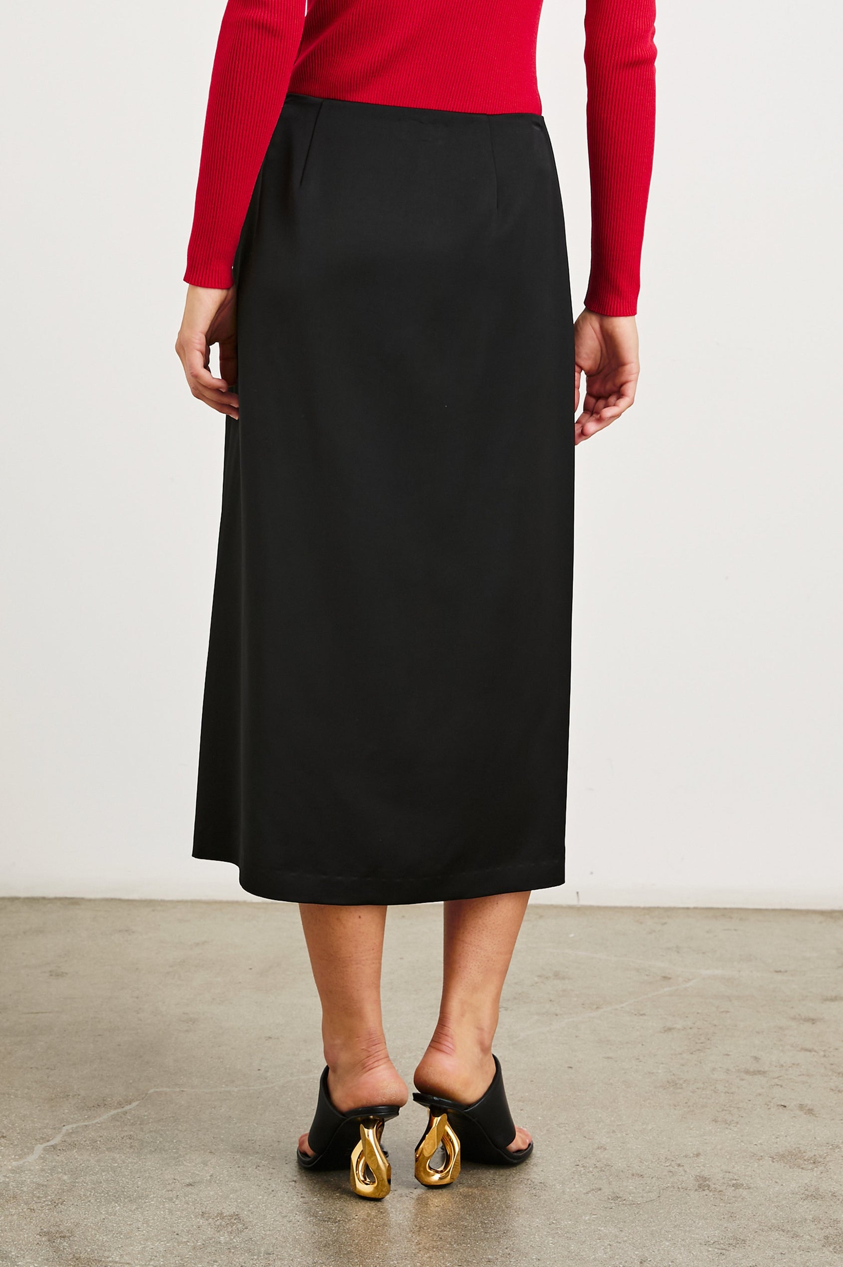 Kira Midi Skirt with a Side Slit and an Inner Midi Skirt in Black Colorway - Back View Featured on Model 