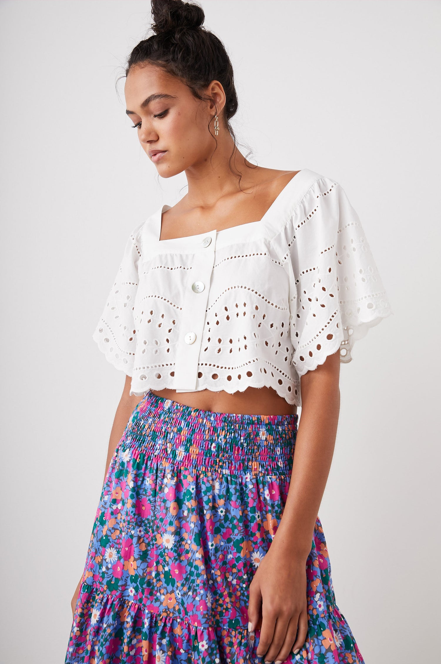 Kit Short Sleeve Crop Top with a Square Neckline, Front Button Closure, and an Eyelet Design in White Eyelet Embroidery Colorway - Front View Featured on Model 