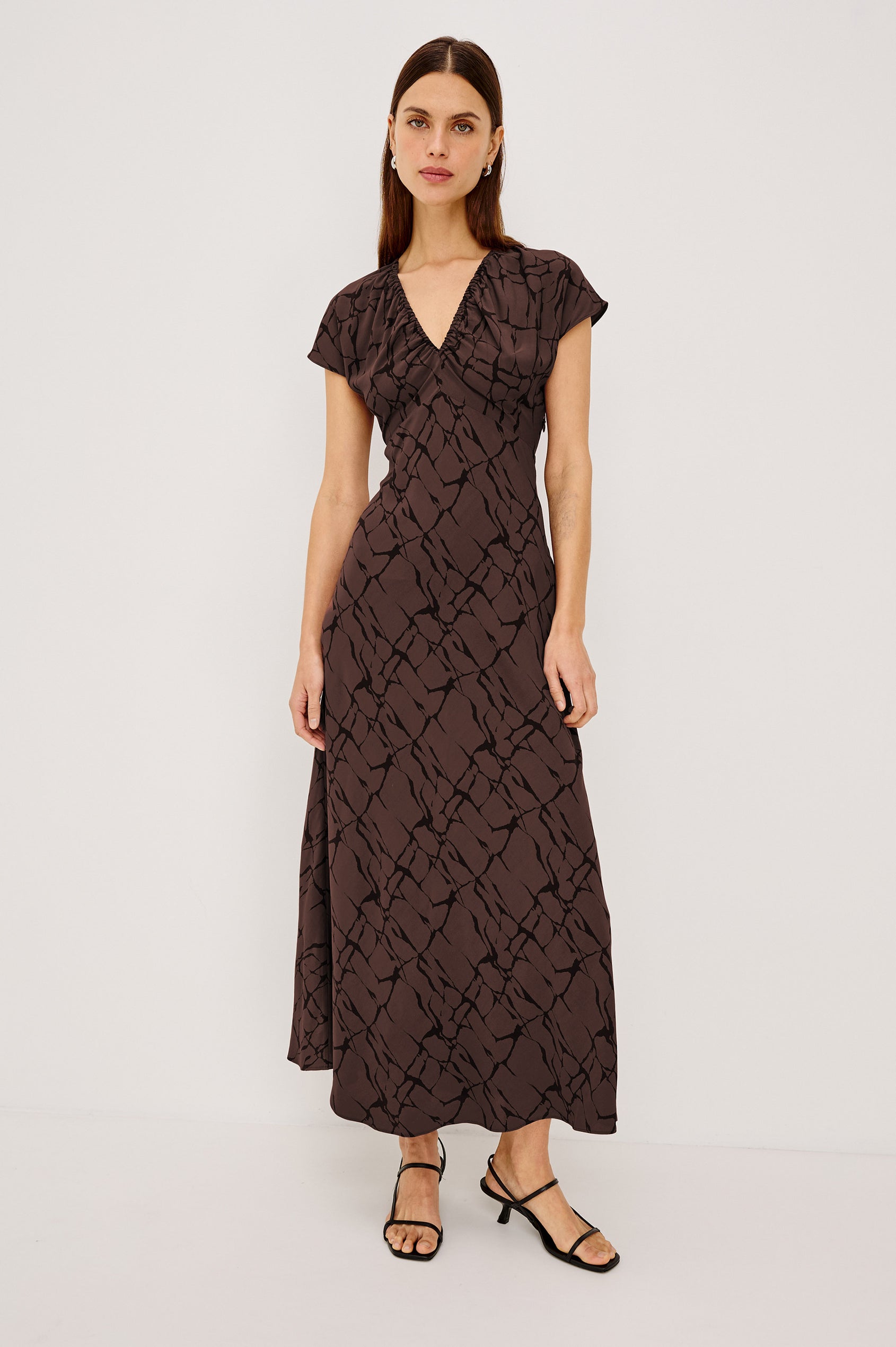 Kourt Midi Dress in Lightweight Crepe With Elastic V-Neckline, Empire Waist, Extended Cap Sleeves, and Hidden Side Zip in Brown Obsidian Colorway - Full Body Front View Featured on Model