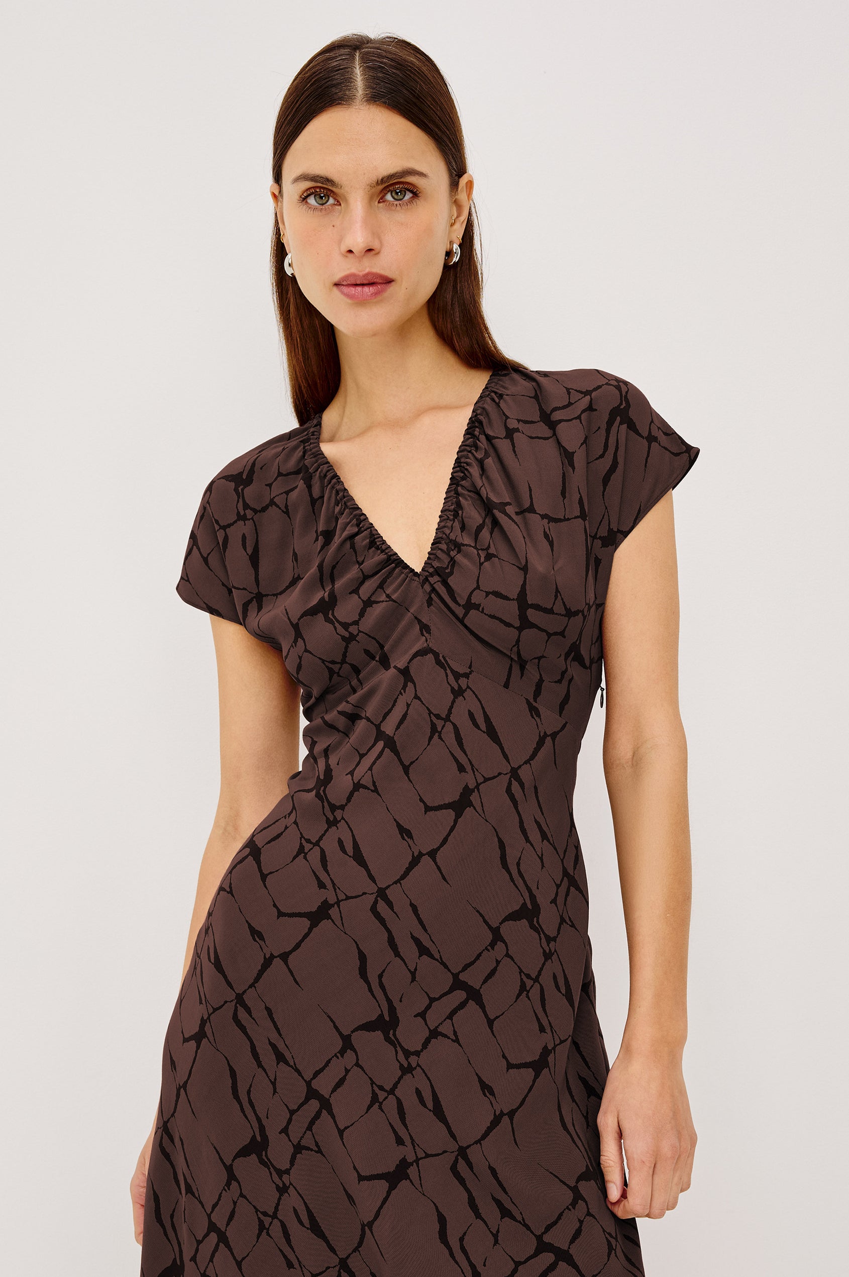 Kourt Midi Dress in Lightweight Crepe With Elastic V-Neckline, Empire Waist, Extended Cap Sleeves, and Hidden Side Zip in Brown Obsidian Colorway - Upper Body Front View Featured on Model