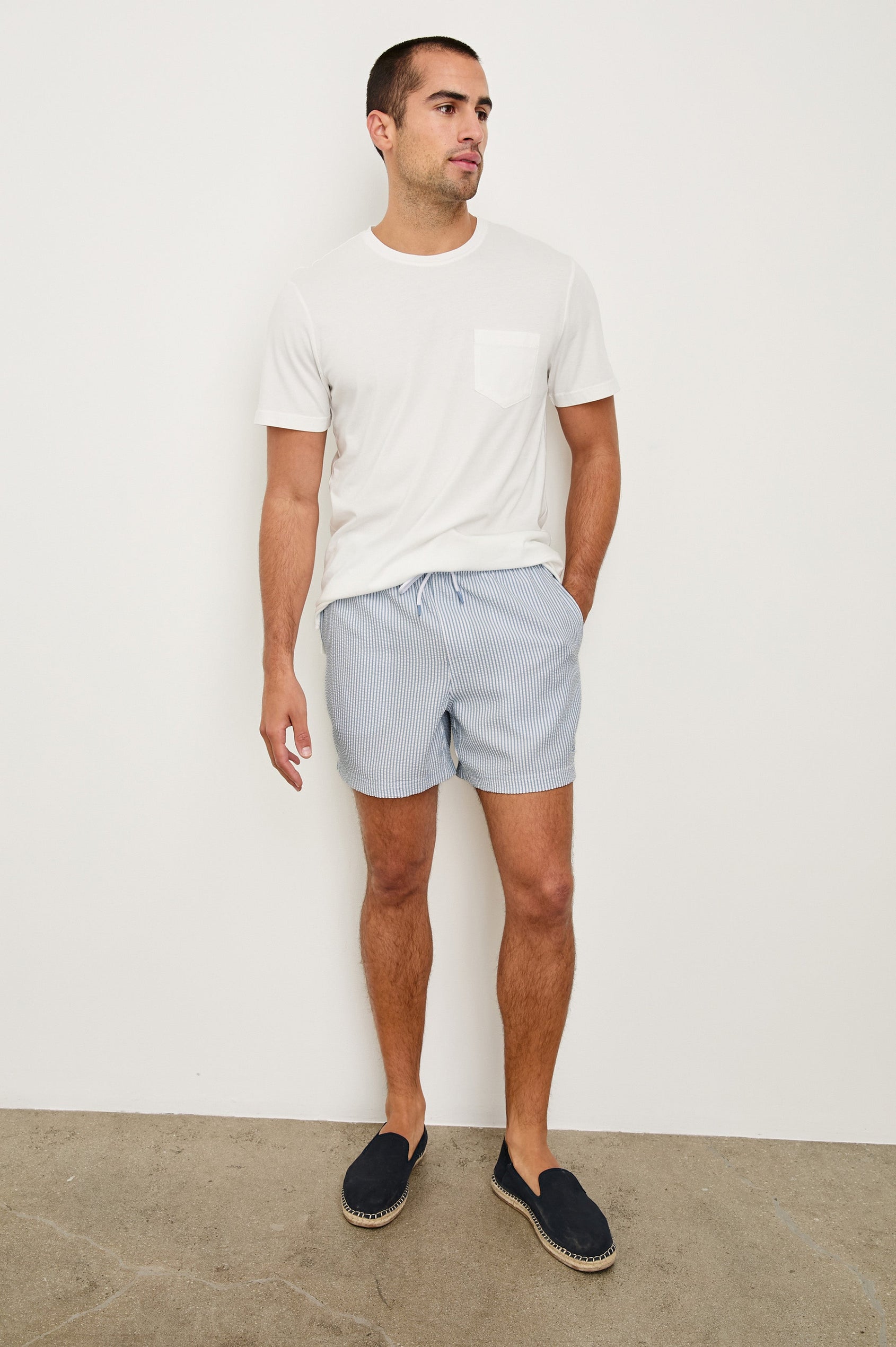 La Brea textured mid-length swim short with adjustable waist drawstring in Blue White Seersucker - full body front view on model