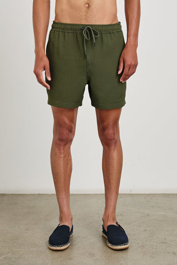 La Brea textured mid-length swim short with adjustable waist drawstring in Olive Seersucker - front view on model