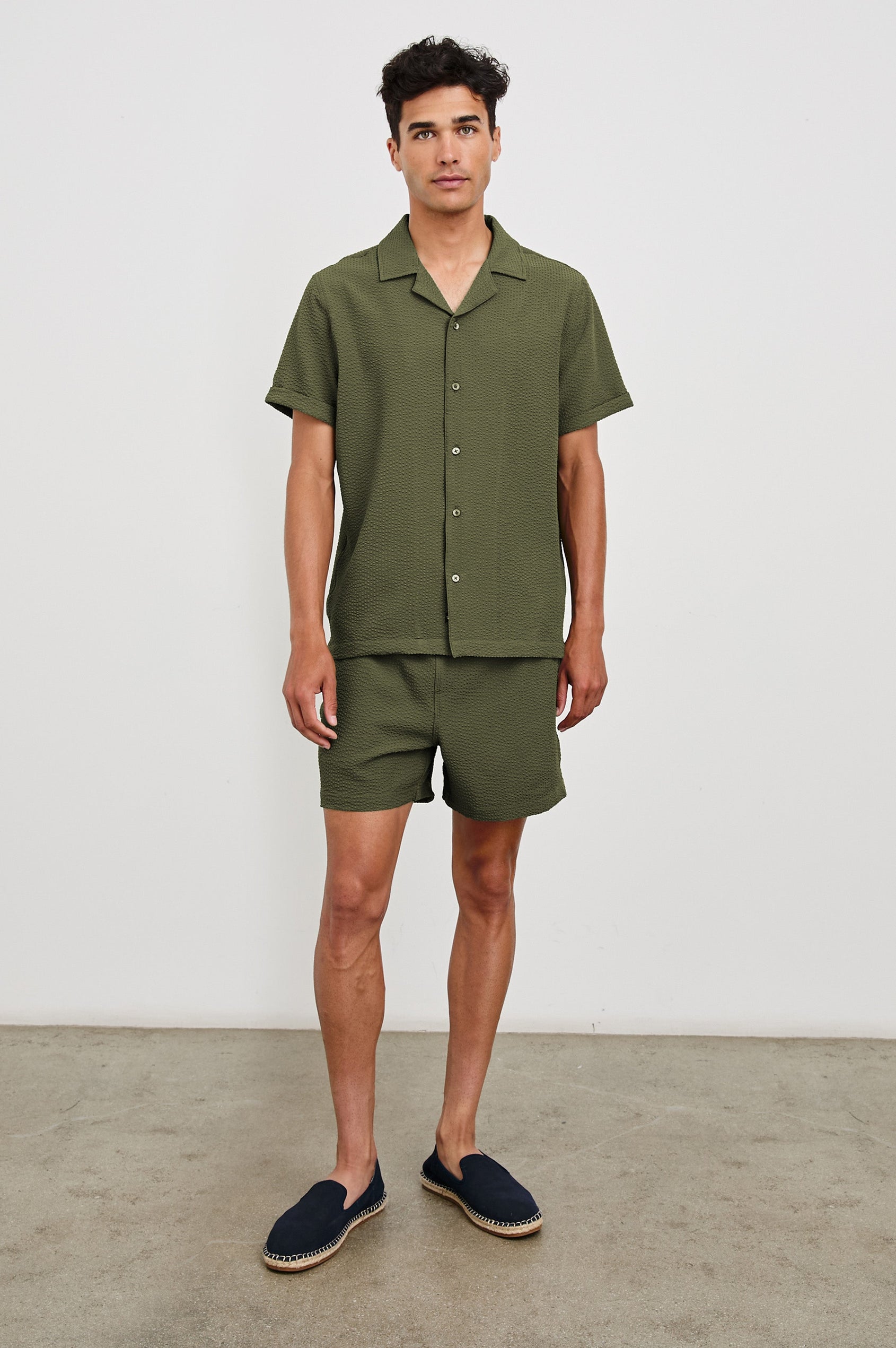 La Brea textured mid-length swim short with adjustable waist drawstring in Olive Seersucker - full body front view on model