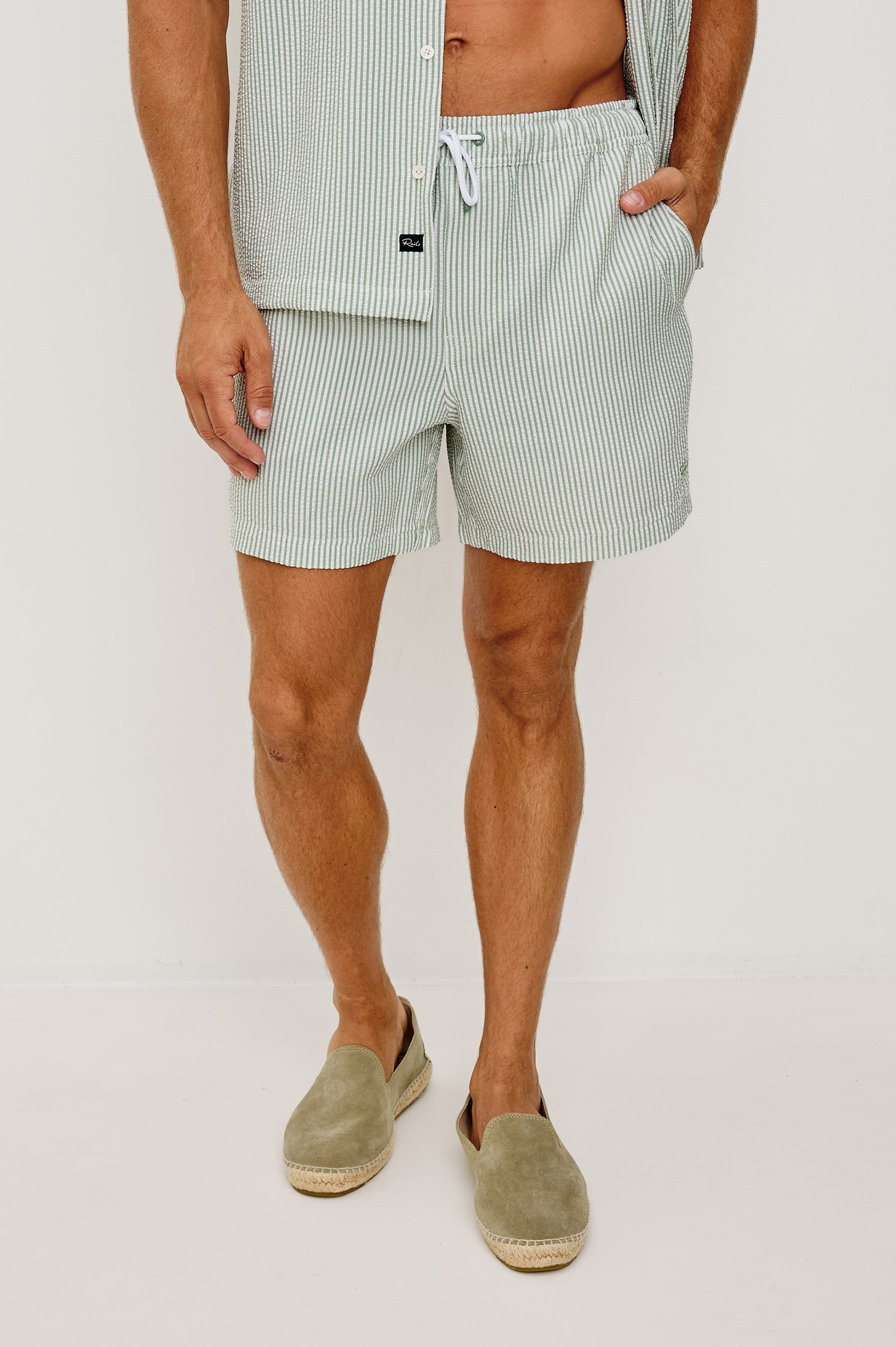The Amalfi Button-Up Short Sleeve Shirt in Lightweight Stretch Linen-Blend With a Notched Collar and Classic Fit in Sage White Seersucker - Lower Body Front View Featured on Model