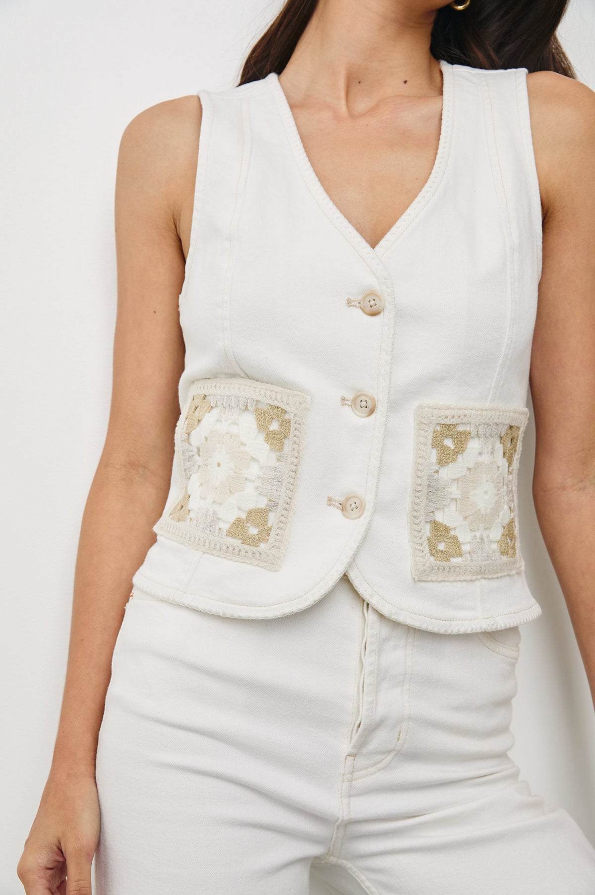 La Jolla Denim Vest with a V-Neck, Button Front and Embroidered Front Patch Pockets in Vintage Ecru Crochet Colorway. Front View Shown on Model.