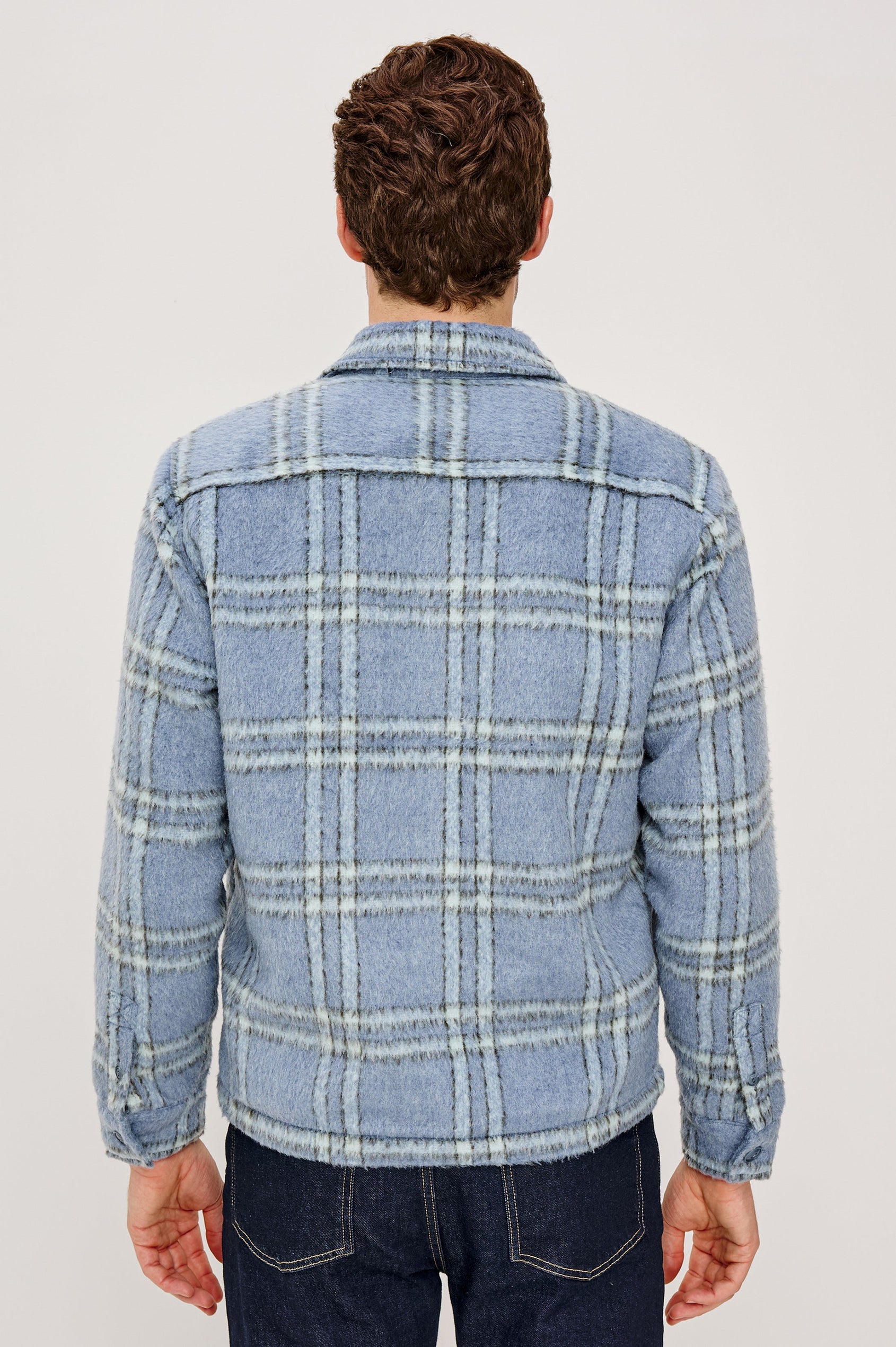 Lachlan is a fully lined shirt jacket with a classic collar, front buttons, chest patch pockets in Blue Lotus colorway. Back view featured on model.