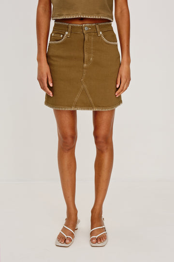 Laurel 5-Pocket Colored Denim Mini Skirt With Blanket Stitch Along All Edges in Safari Embroidered. Front View Shown on Model.