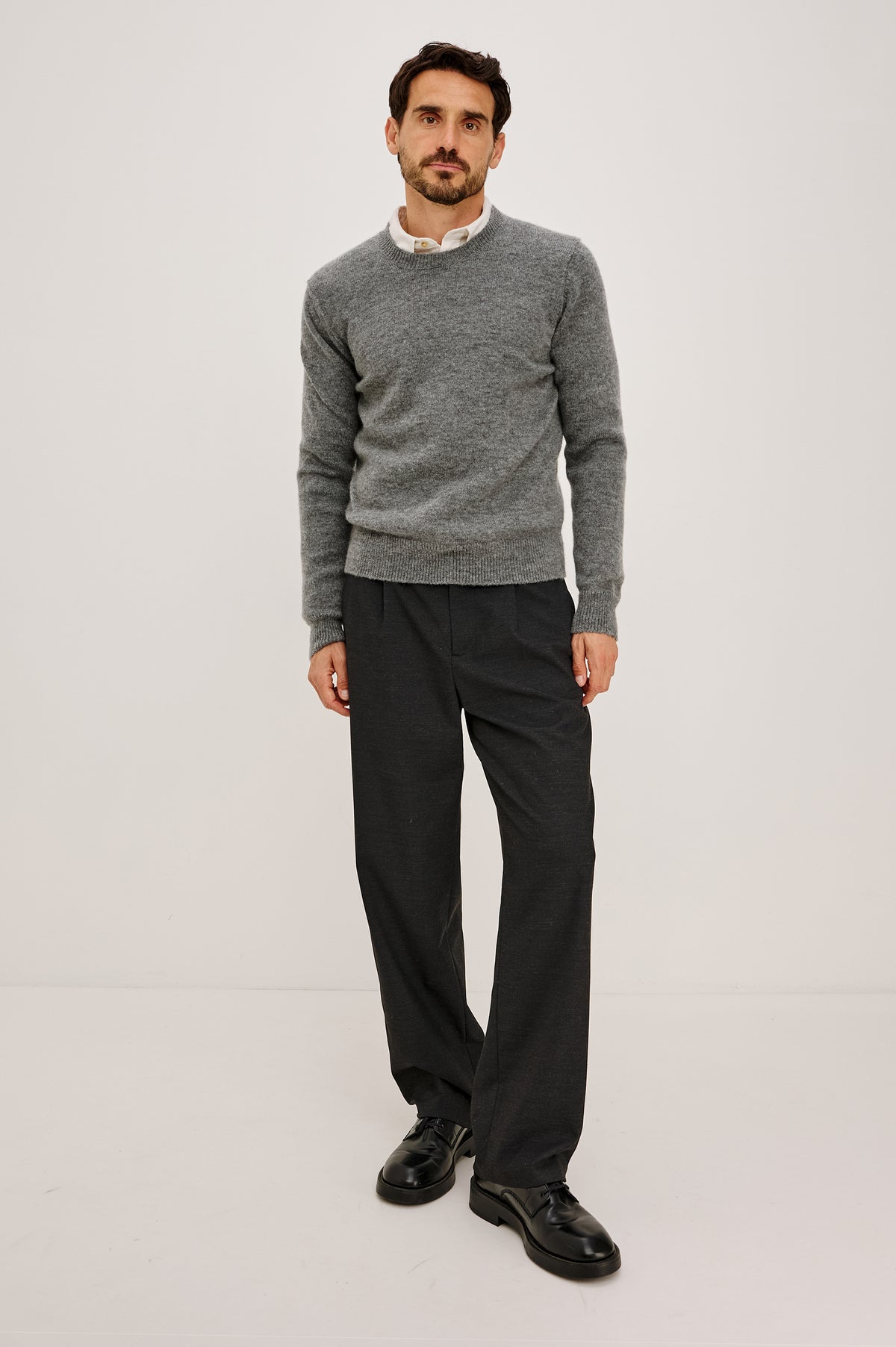 Laurent Sweater in Wool Blend With Crewneck, Dropped Shoulders, Linked Stitch Detailing, and Long Sleeves in Charcoal Colorway - Full Body Front View Featured on Model