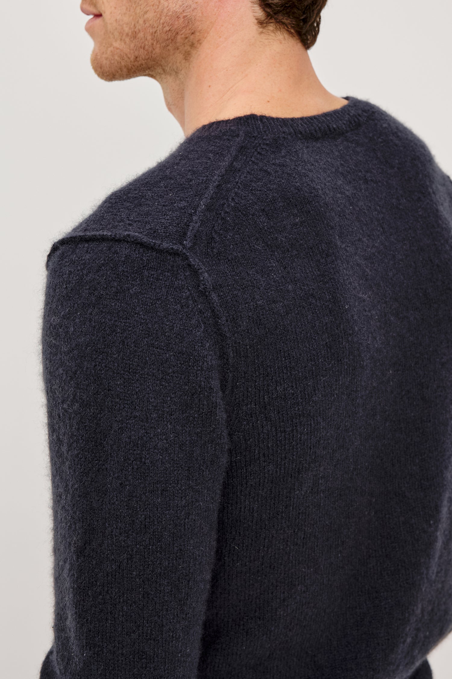 Laurent Crewneck Sweater in Wool Blend With Dropped Shoulders With Linking Stitch Detailing and Long Sleeves in Midnight Colorway - Back Close Up View Featured on Model
