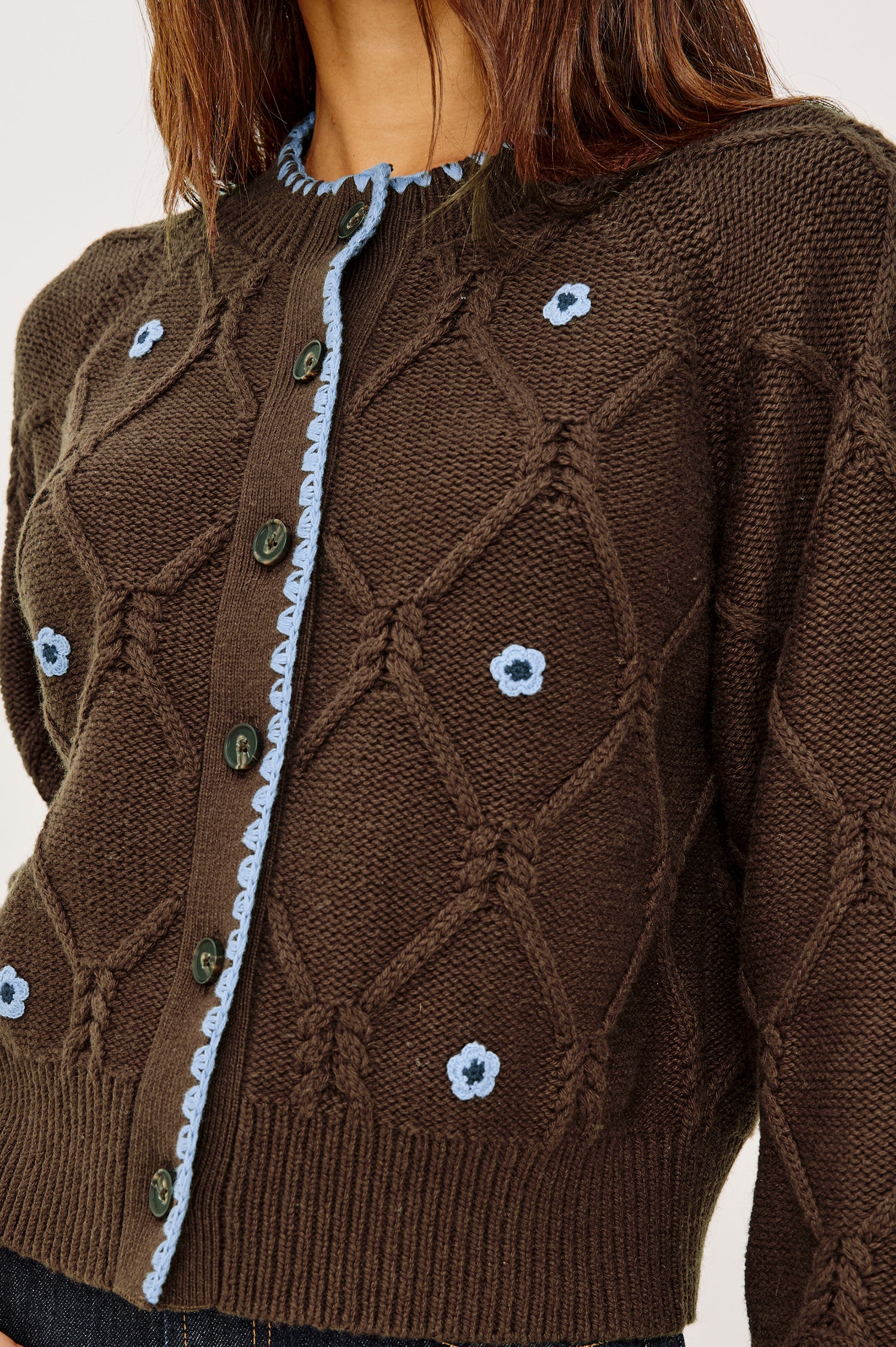 Laurie Cardigan in Cable Knit With Diamond Detailing, Floral Embroidery, Contrast Blanket Stitching, Front Buttons, Long Sleeves, and Ribbed Trim in Walnut Daisy Colorway - Upper Body Close Up Front View Featured on Model